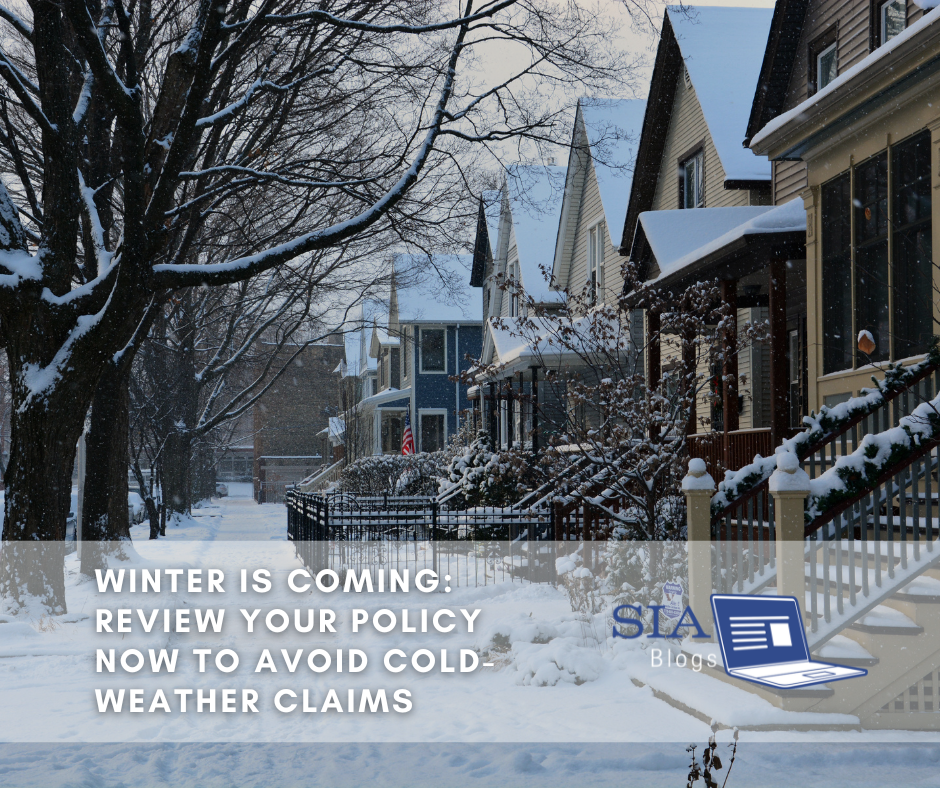 This image shows a snow-covered residential neighborhood with several houses and leafless trees lining the street. The caption overlay reads, "Winter is Coming: Review Your Policy Now to Avoid Cold-Weather Claims," along with the SIA Blogs logo.