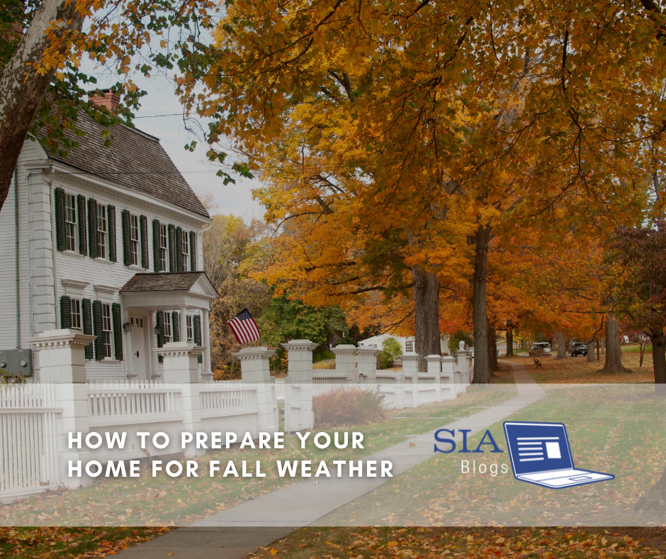 The scene depicts a white house surrounded by trees with vibrant autumn leaves, set against a fall backdrop. The caption overlay reads, "How to Prepare Your Home for Fall Weather," along with the SIA Blogs logo.