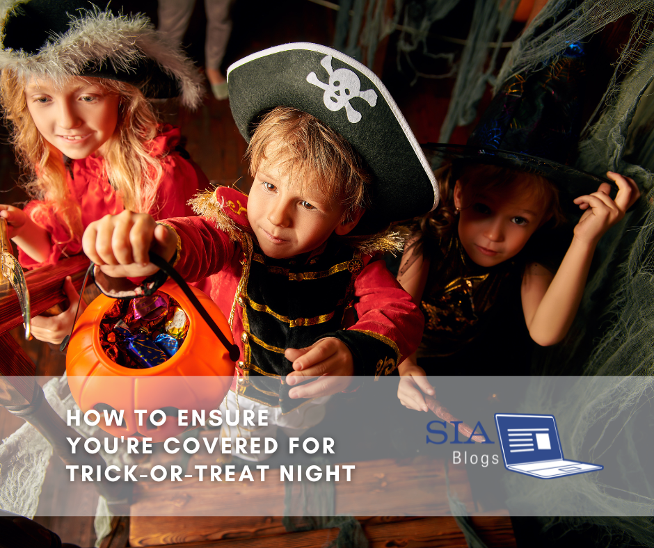 Three children dressed in Halloween costumes, including a pirate and a witch, hold a candy bucket filled with treats. The caption overlay reads, "How to Ensure You're Covered for Trick-or-Treat Night," along with the SIA Blogs logo.