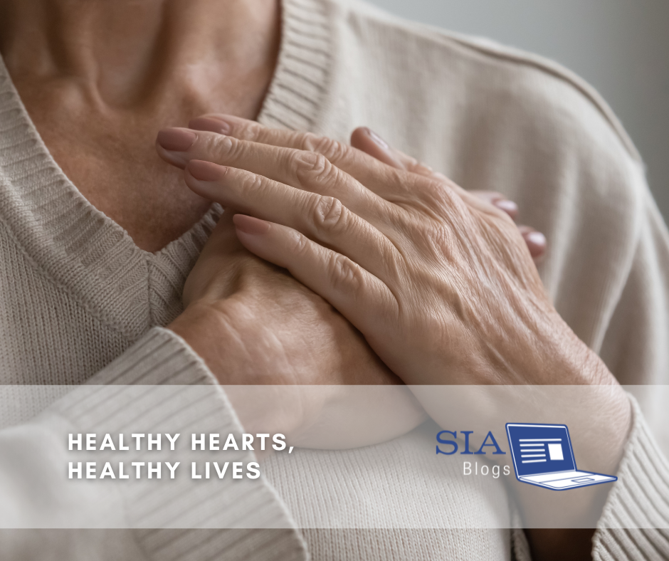 The image shows an elderly person gently resting their hands over their chest, possibly in a gesture of care or focus on heart health. The scene highlights the importance of maintaining a healthy heart for a healthy life.